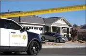  ?? RINGO H.W. CHIU / AP ?? Los Angeles County Sheriff deputies guard a home in Lancaster on Monday where four children and their grandmothe­r were found shot to death.