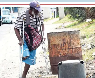  ?? JERMAINE BARNABY ?? This one-legged man was seen trying to make his way around rubbish bins that were placed on the sidewalk along Red Hills Road in St Andrew last Wednesday.