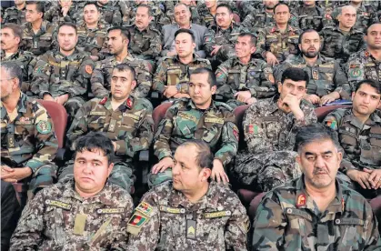  ?? OMAR SOBHANI REUTERS ?? Afghan army officers listen to a speech by President Ashraf Ghani during an event with Afghan security forces in Kabul, Afghanista­nm, on Sept. 9. •