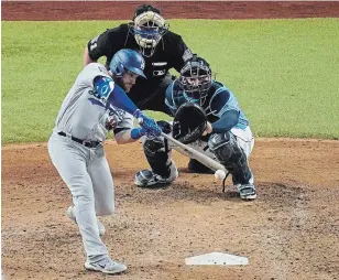  ?? SUE OGROCKI THE ASSOCIATED PRESS ?? Los Angeles Dodgers first baseman Max Muncy hits a home run against the Tampa Bay Rays during the fifth inning in Game 5 of the World Series Sunday in Arlington, Texas.