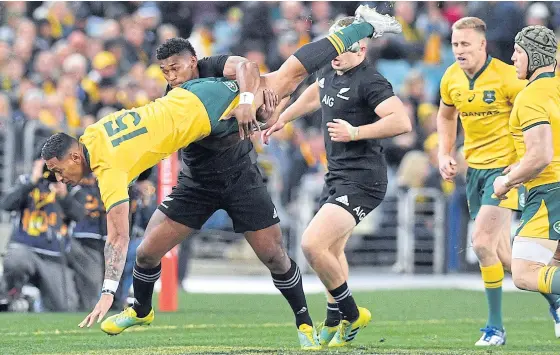  ??  ?? New Zealand’s Waisake Naholo tackles Australia’s Israel Folau during their Rugby Championsh­ip Bledisloe Cup Test match in Sydney.