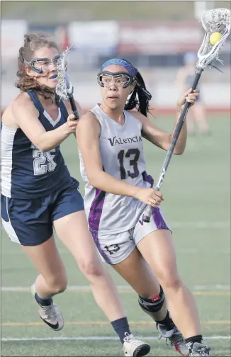  ?? Nikolas Samuels/The Signal ?? Valencia’s Katherine Lin (13) takes the ball down field during a home game against Crescenta Valley on Friday. Valencia lost the game 13-4.