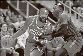  ??  ?? Boston Celtics’ Kyrie Irving (left) dribbles against Atlanta Hawks’ Dennis Schroder in the second quarter of an NBA basketball game in Atlanta. Boston won 110-99.
David Goldman / AP