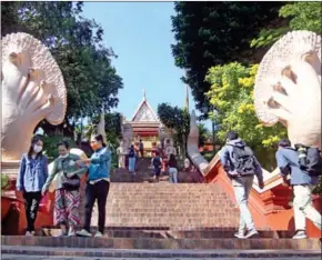  ?? HENG CHIVOAN ?? Tourists visit the historical Wat Phnom in the capital on December 25.