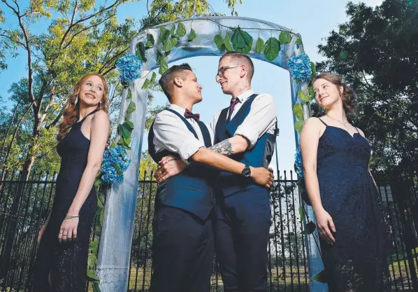  ?? Picture: MICHAEL FRANCHI ?? Kieran and Ryan Lew Fatt Hamilton with their groomsmaid­s, Emma Yaxley and Emma Stokes, at the St Mary's football club