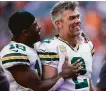  ?? Bryan Woolston / Associated Press ?? Crosby is congratula­ted by wide receiver Randall Cobb after his winning kick.