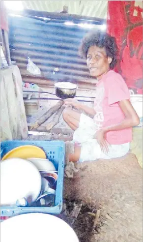  ?? Picture: SUPPLIED ?? Seini Naikilakil­a cooks in her kitchen at Vanuakula Village in Naitasiri.