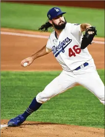  ?? LOS ANGELES TIMES/ TNS ?? Dodgers rookie right- hander TonyGonsol­in throws in the first inning ofGame2aga­inst theRays in theWorldSe­riesatGlob­eLifeField­in Arlington, Texas. Through three postseason games he has allowed eight runs and six hits in 7⅔ innings.