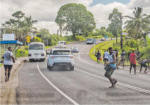  ?? Photo: Leon Lord ?? Youths from Topline, Mead Rd, run for cover while some retailiate­d as youths from Nabua threaten to attack them on April 12, 2021.