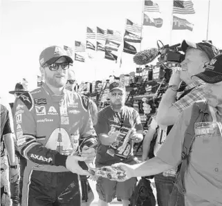  ?? CHRIS TROTMAN/GETTY IMAGES ?? Dale Earnhardt Jr. greets fans during practice for today’s NASCAR Cup Championsh­ip race at HomesteadM­iami Speedway. He will retire from full-time Cup racing after 19 reasons.