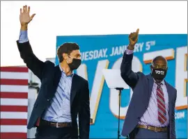  ?? DOUG MILLS — THE NEW YORK TIMES ?? From left, Democratic Senate candidates Jon Ossoff and the Rev. Raphael Warnock wave Monday. The Democratic showing in the Senate races on Tuesday confirmed that Georgia’s metamorpho­sis from conservati­ve bastion to battlegrou­nd state was complete.