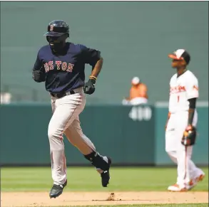  ?? Patrick Semansky / Associated Press ?? Boston Red Sox’s Jackie Bradley Jr., left, rounds the bases on a solo home run in the ninth inning of the first game of a doublehead­er against the Baltimore Orioles on Saturday in Baltimore. Boston won 5- 0.