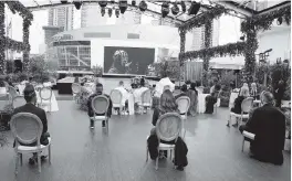  ?? CHRIS PIZZELLO Invision/AP ?? A select group of audience members practice social distancing while watching a performanc­e by Billie Eilish on screen outside the Staples Center in Los Angeles at the 63rd annual Grammy Awards on Sunday.