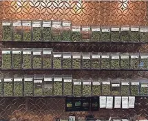  ?? TREVOR HUGHES, USA TODAY ?? Glass jars of high-grade Colorado-grown marijuana sit on a shelf at a Pueblo-area cannabis store.