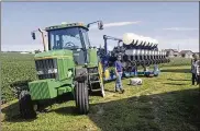  ?? TOM HENRY / THE (TOLEDO) BLADE ?? Fifth-generation farmer Chris Kurt uses this planter to grow corn and beans in Hardin County.