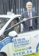  ?? RYAN REMIORZ/THE CANADIAN PRESS ?? Federal Transport Minister Marc Garneau checks out the Chevrolet Volt at the Electric Vehicle Show last month in Montreal. Provincial subsidies to encourage the use of electric vehicles are the most expensive, least effective way to help cut greenhouse...