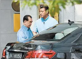  ?? ROSLAN RAHMAN/GETTY-AFP ?? Kim Chang Son, left, a top aide of North Korea’s Kim Jong Un, leaves a Singapore hotel.