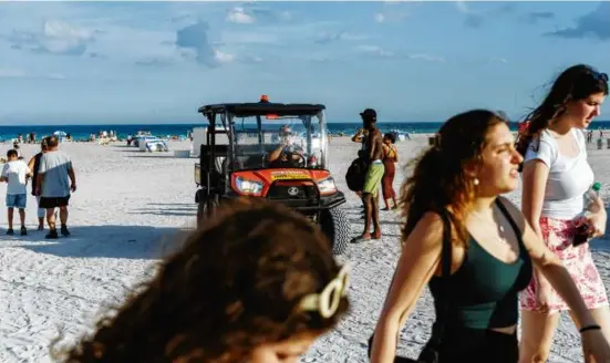  ?? JAMES JACKMAN/NEW YORK TIMES ?? A law enforcemen­t official in an ATV patrolled Thursday on Miami Beach, where access is being restricted after 6 p.m.