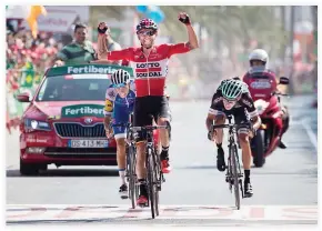  ??  ?? Lotto Soudal’s Polish cyclist Tomasz Marczynski celebrates as he crosses the finish line to win the 6th stage of the 72nd edition of ‘La Vuelta’ Tour of Spain cycling race on Thursday. (AFP)