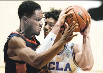  ?? Gregory Bull Associated Press ?? UCLA’S Jules Bernard tries to get past Pepperdine center Victor Ohia Obioha en route to the Bruins’ win.