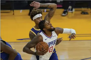  ?? JEFF CHIU — THE ASSOCIATED PRESS ?? Clippers guard Paul George (13) drives against Warriors forward Kelly Oubre Jr. during the first half on Wednesday.