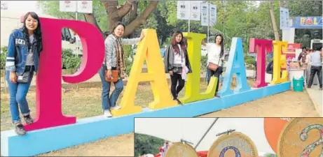  ??  ?? Young girls strike a pose with an installati­on at the HT Palate Fest