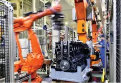  ?? PHOTO XINHUA ?? This April 22, 2021 file photo shows robots assembling engines at a Weichai Power Co. Ltd. factory in the city of Weifang in China’s eastern Shandong province.