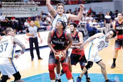  ??  ?? Jason Perkins of Phoenix (No. 3) fakes against NLEX’s Paul Asi Taulava as Jay-R Quiñahan (No. 37), Larry Fonacier (No. 12), Ron Dennison look on during a Season 44 PBA Philippine Cup game on Friday at the Mall of Asia Arena in Pasay City.