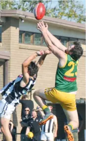  ??  ?? Hill End’s Lachlan Paul leaps high but was unable to take the mark against Yinnar.