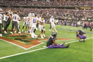  ?? (AP Photo/lm Otero) ?? Kansas State players celebrate Saturday as TCU’S Tre’vius Hodges-tomlinson (1) sits in the end zone with Dee Winters (13) after Kansas State defeated TCU in overtime of the Big 12 Conference championsh­ip NCAA college football game in Arlington, Texas.