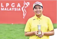  ??  ?? Winnie Ng with her trophy after being named Malaysia’s best player at the Sime Darby LPGA Malaysia golf tournament at the TPC Kuala Lumpur yesterday - Bernama photo
