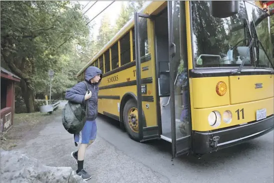  ?? HIGH SCHOOL STUDENTS Photograph­s by Paul Kuroda For The Times ?? board the morning bus in Camp Meeker, Calif., an unincorpor­ated community in Sonoma County just minutes from the ocean.