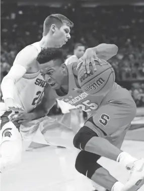  ??  ?? Syracuse guard Tyus Battle drives against Michigan State guard Matt McQuaid during a second-round NCAA Tournament game Sunday Detroit. PAUL SANCYA/AP