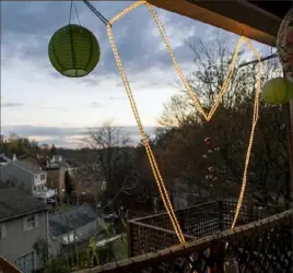  ?? Emily Matthews/Post-Gazette ?? A light-up heart decorates the back porch of Jena-Anne Sabom’s home on April 6 on Virginia Avenue in Mount Washington.