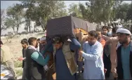  ?? (AP) ?? At a funeral Wednesday in Jalalabad, Afghanista­n, relatives carry the casket of a woman killed Tuesday in attacks claimed by the Islamic State.