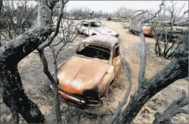  ?? Luis Sinco Los Angeles Times ?? THE NORTH FIRE, which temporaril­y shut down Interstate 15 in the Cajon Pass and destroyed vehicles, was 45% contained after scattered storms Saturday.