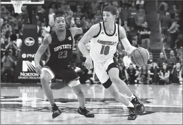  ?? AP/TIMOTHY D. EASLEY ?? Louisville guard Samuell Williamson (10) brings the ball up court past the defense of USC Upstate guard Thomas Booker (23) on Wednesday during the second half in Louisville, Ky. Louisville won 76-50.