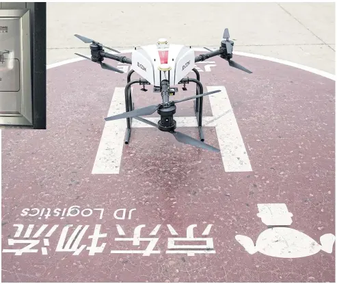  ?? PHOTOS BY BLOOMBERG ?? A JD.com drone sits during a package delivery demonstrat­ion at a launch pad of the company’s drone testing site in Xi’an.