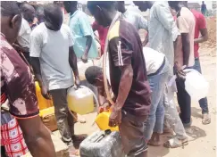  ?? Photo: Faruk Shuaib ?? Roadside fuel sellers make brisk business at Abuja’s Banex Junction as major fuel stations remain shut on Tuesday