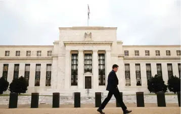  ?? — Reuters ?? A man walks past the Federal Reserve Bank in Washington DC.
