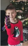 ?? THE CANADIAN PRESS / HO ?? Isaac Comstock, 7, shows off his Cadbury Dairy Milk Silk Bubbly bar, which is not available in Canada.