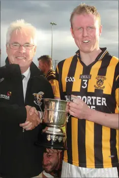  ??  ?? Kevin O’Leary is presented with the cup by Diarmuid Devereux.