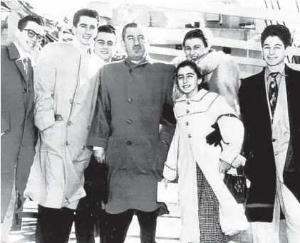  ?? 1952 HANDOUT PHOTO ?? Surrounded by family, windswept Mayor Thomas D'Alesandro Jr. prepares to sail on a Caribbean cruise from New York aboard SS Italia. Family members, who aren't going, are from left: Nick, 17; Tommy, 22; Frank, 19; Mrs. D'Alesandro; Nancy, 12, and Joseph, 15.