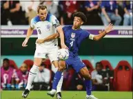  ?? Julio Cortez / Associated Press ?? England’s Harry Kane, left, fights for the ball against Tyler Adams of the United States during the World Cup group B soccer match Friday at the Al Bayt Stadium in Al Khor, Qatar.