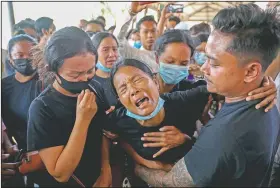  ??  ?? Thida Hnin cries during the funeral of her husband Thet Naing Win at Kyarnikan cemetery in Mandalay. Thet Naing Win was shot and killed by Myanmar security forces during an anti-coup protest on Feb. 20.