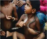  ??  ?? The son of an Indian snake charmer holds a cobra snake around his neck in Kapari village, around 40km southwest of Allahabad in Uttar Pradesh state.