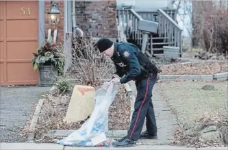  ?? CHRIS YOUNG THE CANADIAN PRESS ?? The discovery of skeletal remains in planters and police allegation that a serial killer is responsibl­e for the crimes have prompted one homicide expert to suggest the perpetrato­r is likely a psychopath. A police officer outside a house on Mallory...