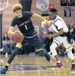  ?? Allen J. Schaben Los Angeles Times ?? CHINO HILLS guard LaMelo Ball, who scored 27 points, drives against Darren Williams in the Huskies’ 105-70 victory over Rancho Cucamonga.