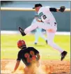  ?? K.M. Cannon ?? Review-journal @ Kmcannonph­oto Silverado’s Tyler Paasche (22) catches a high throw as Las Vegas’ Kevin Verduzco slides into second base Wednesday.