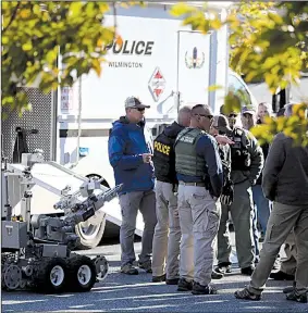  ?? AP/The Philadelph­ia Inquirer/DAVID SWANSON ?? Authoritie­s remove a packaged device from a U.S. Postal Service facility Thursday in Wilmington, Del., that was addressed to former Vice President Joe Biden. Another package addressed to Biden was found at a mail facility in New Castle, Del.